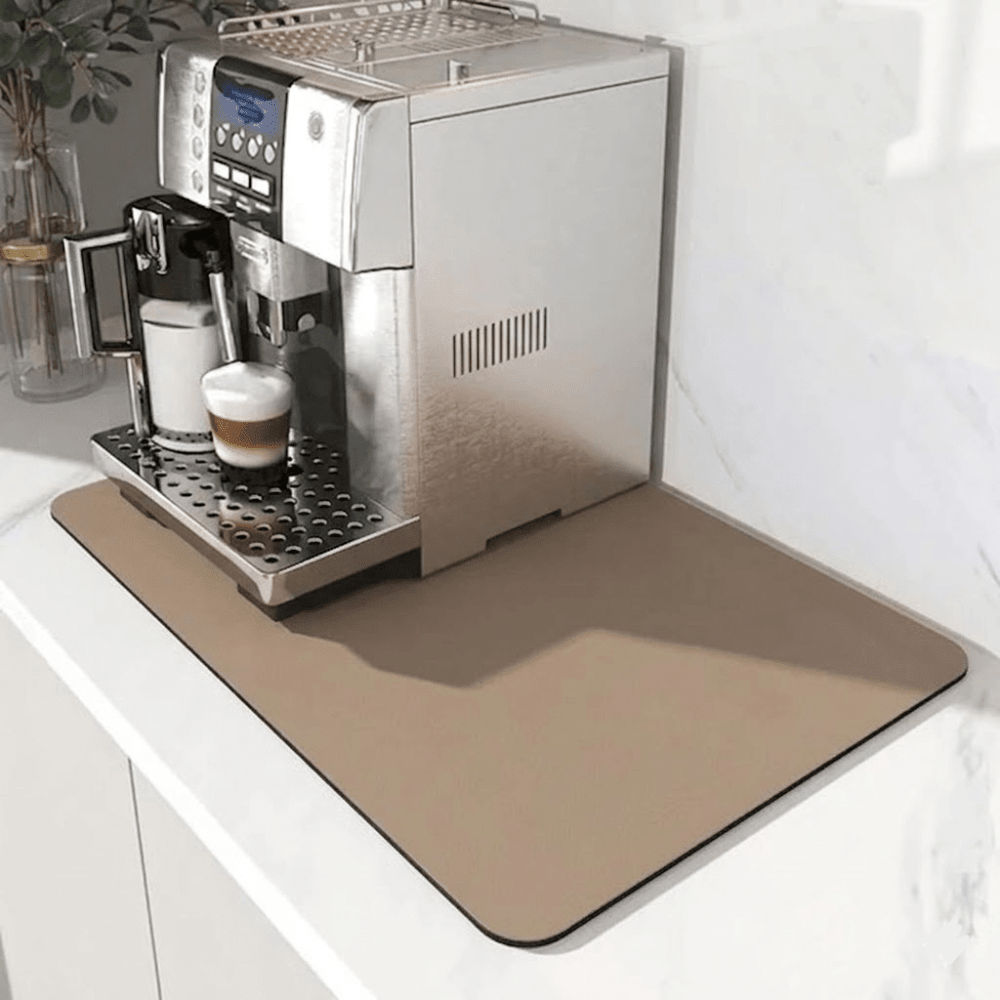 Light tan rectangular mat under a silver espresso machine with a latte on a white marble counter 7