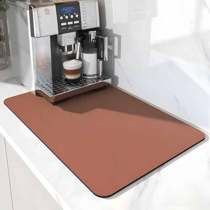 Terracotta brown rectangular mat with rounded corners beneath a coffee machine on a marble counter 10