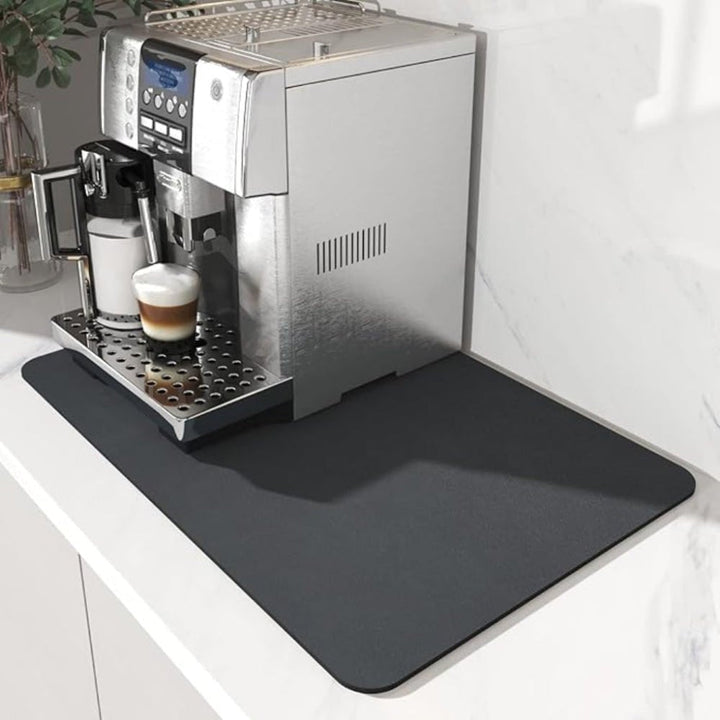 Dark charcoal gray rectangular mat under a silver espresso machine with a latte, on a marble counter 2