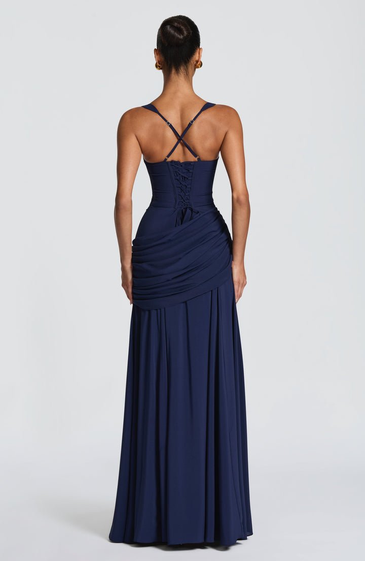 Back of the navy dress, showing lace-up corset closing, crossed adjustable straps and draped hip panel 9