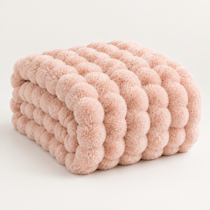 Peach-pink plush blanket folded with large puffy bubble texture on a plain background 15