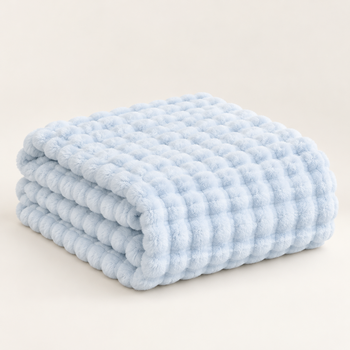 Pale blue plush blanket folded in a neat stack showing its soft ridged bubble texture 17
