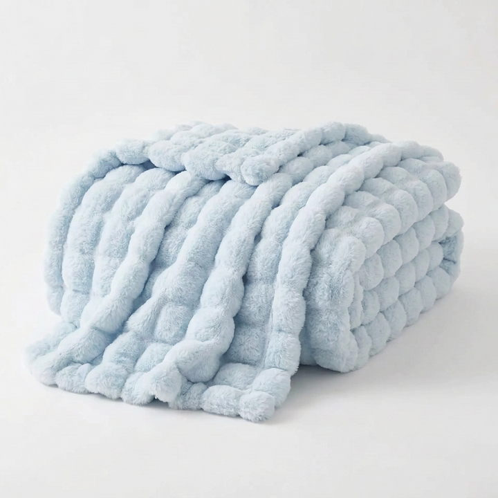 Light blue plush throw folded and draped on a white background, showing its raised bubble texture 13