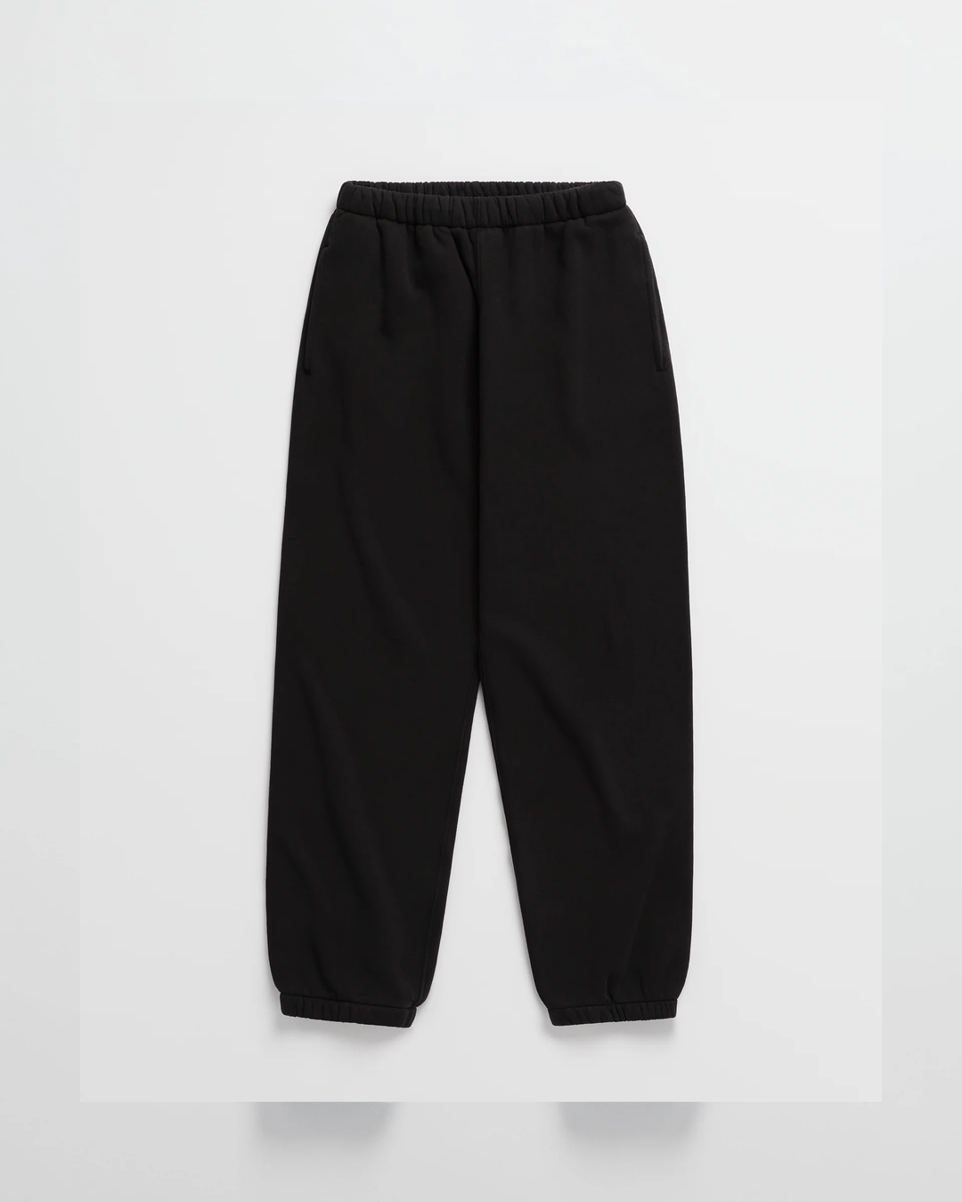 Black jogger sweatpants laid flat, with an elastic waistband, side pockets and gathered ankle cuffs 10