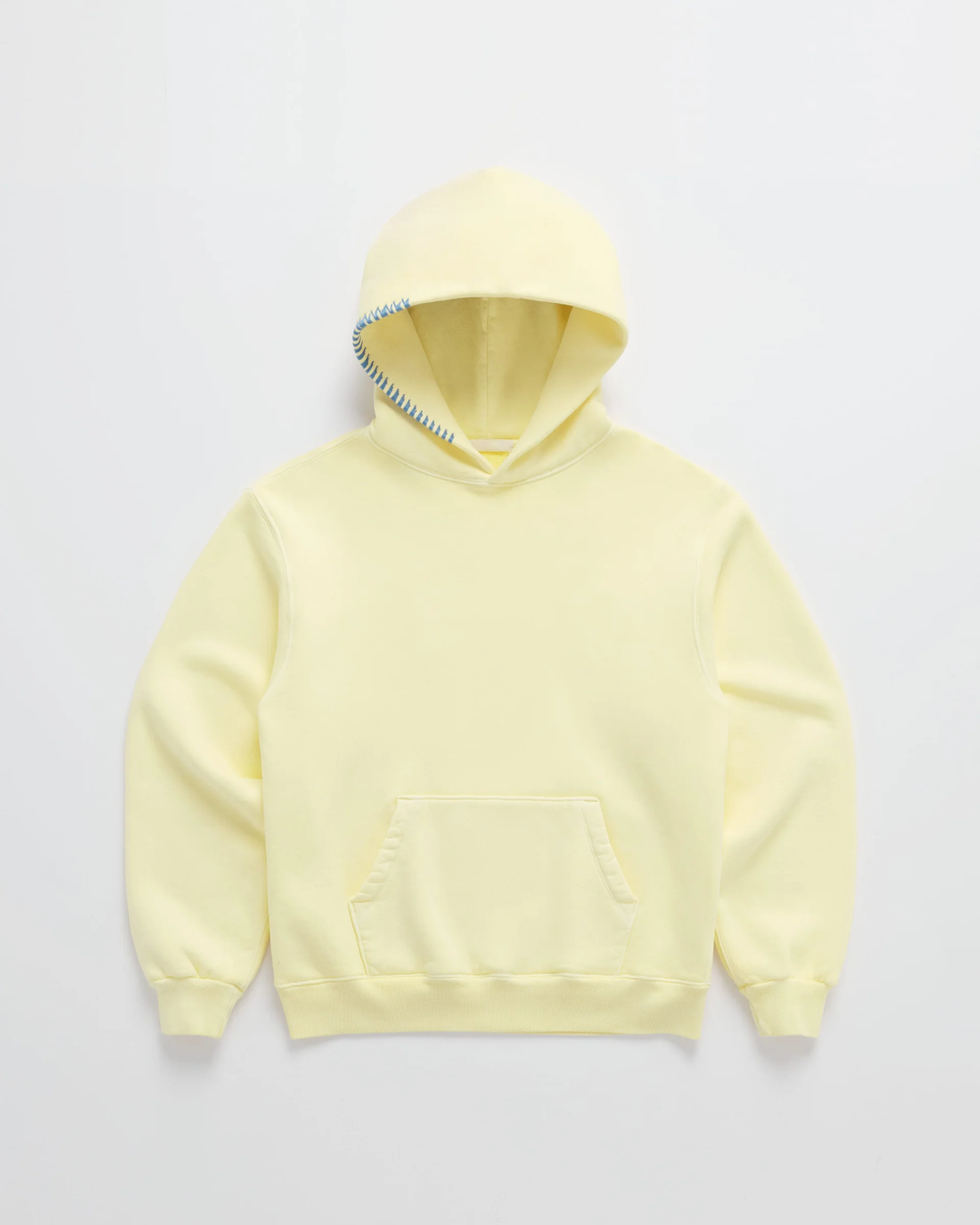 Pale yellow hoodie laid flat, front view, with blue stitching along the hood edge and a kangaroo pocket 1