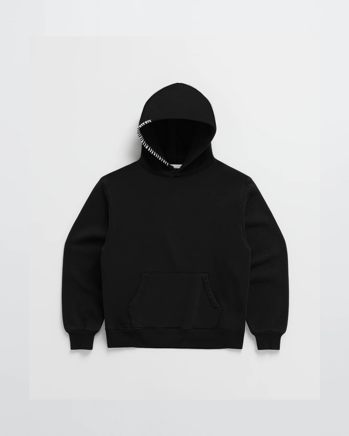 Black hoodie laid flat, front view, with white stitching along the hood edge and a kangaroo pocket 5