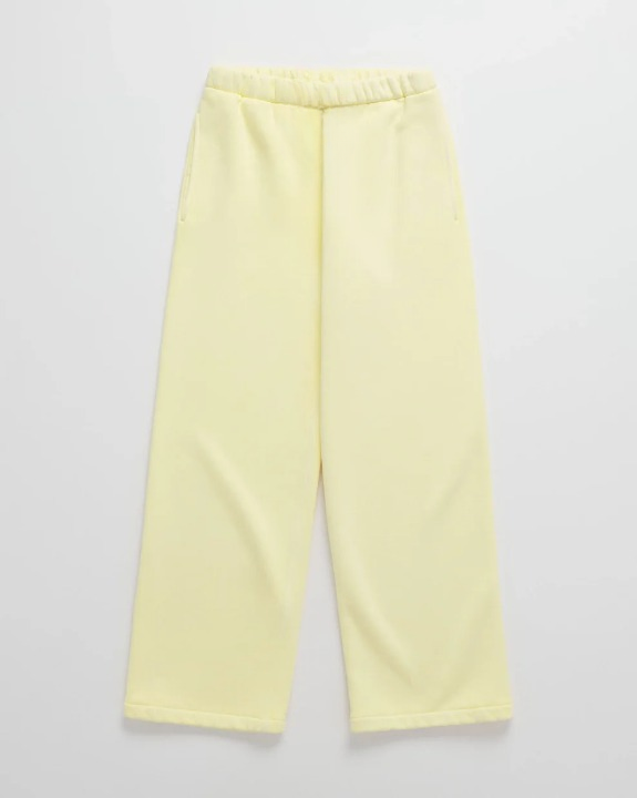 Pale yellow wide-leg sweatpants laid flat, with an elastic waistband and side pockets 6