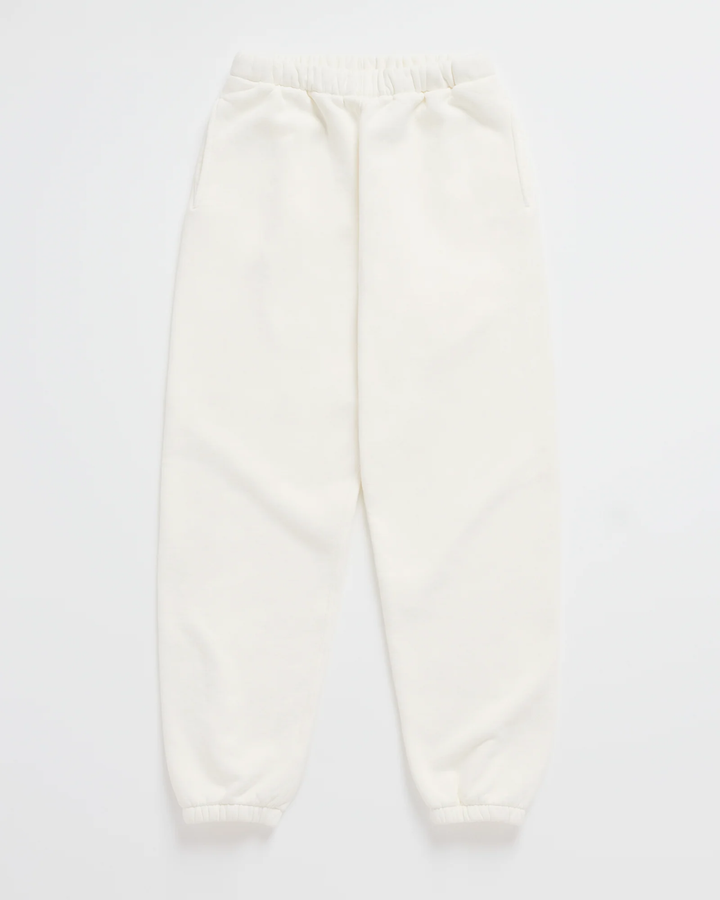 Cream white jogger sweatpants laid flat, with a gathered elastic waistband, side pockets and elastic ankle cuffs 7