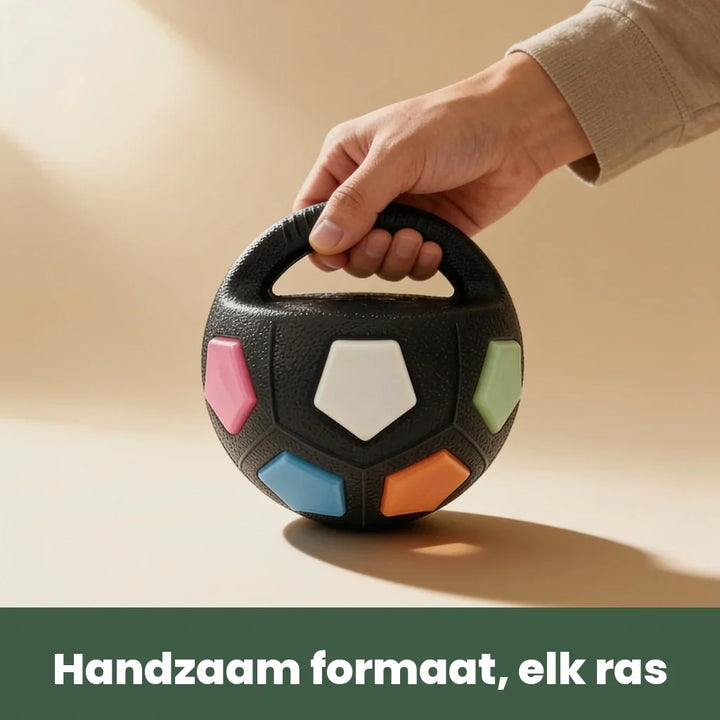 Hand lifting the black ball by its loop handle, another view.