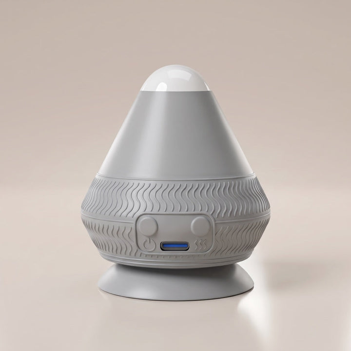 Gray version of the massager on a beige background, with a wavy-patterned grip band, two buttons, and a USB-C port glowing blue. 15