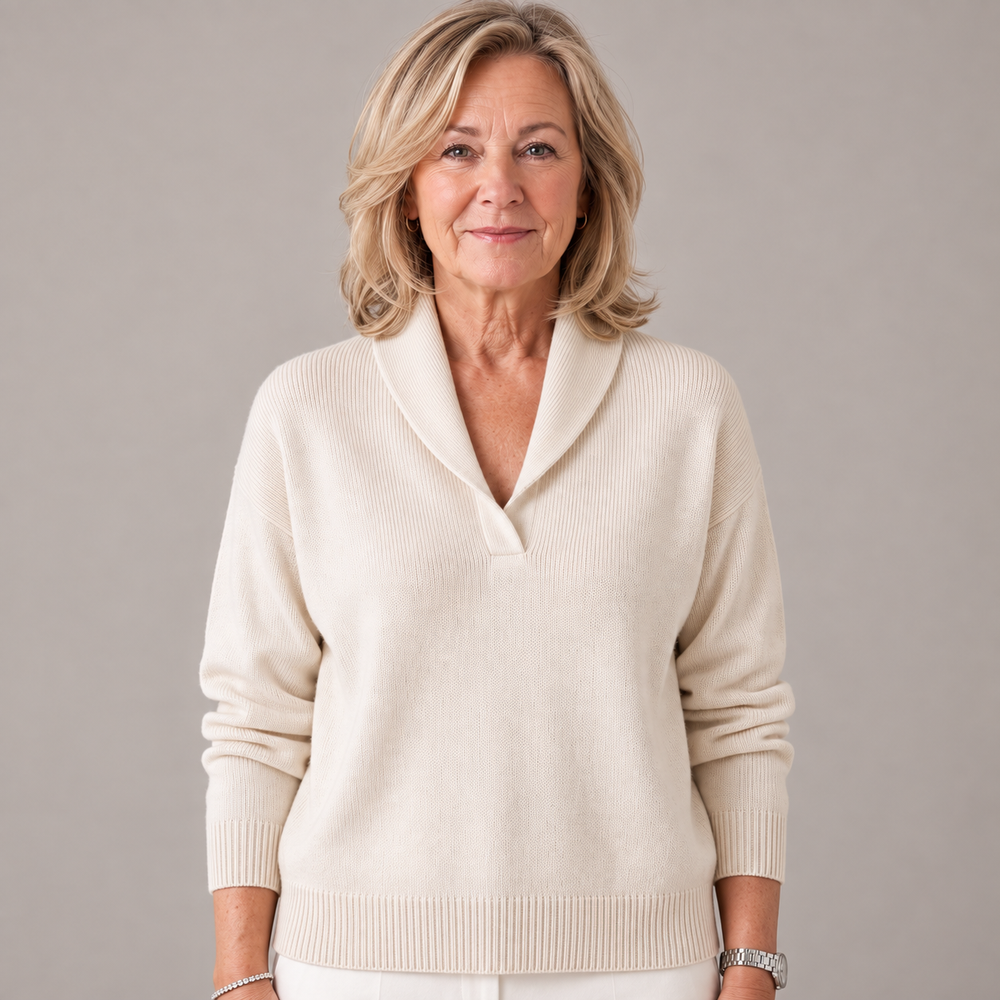 Woman wearing the cream-colored ribbed knit sweater with a shawl collar, front view.
