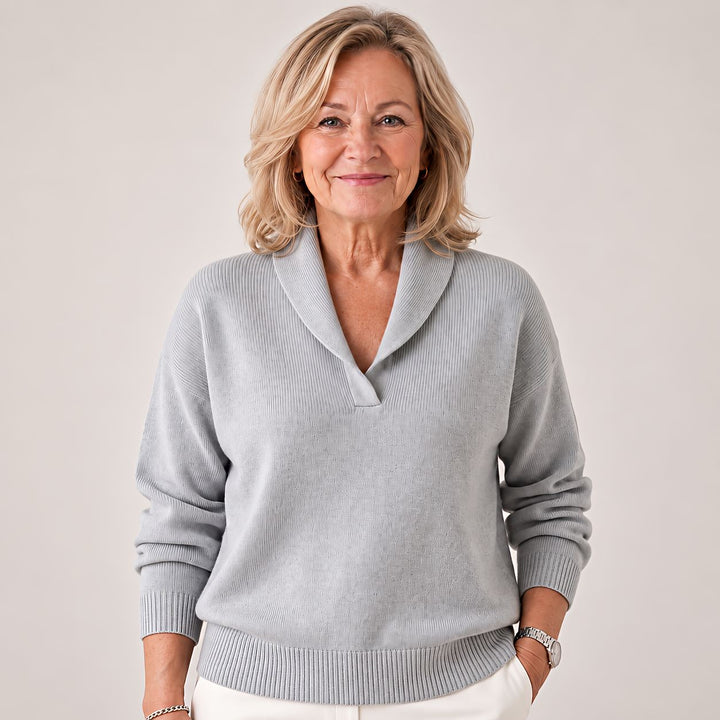 Woman wears the light gray sweater, showing the ribbed cuffs and hem.