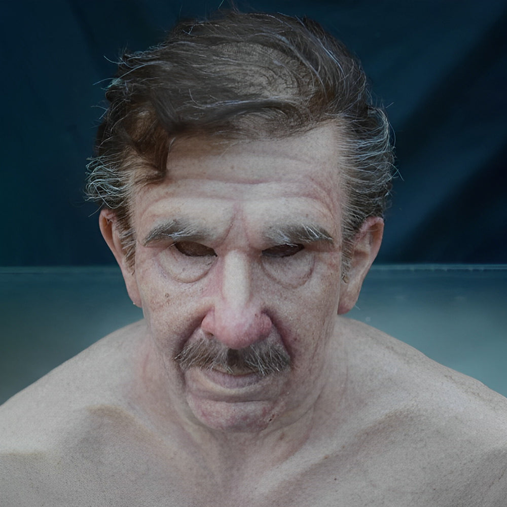 Middle-aged to elderly man mask with swept brown-gray hair, gray mustache and drooping eyelids on a dark teal background
