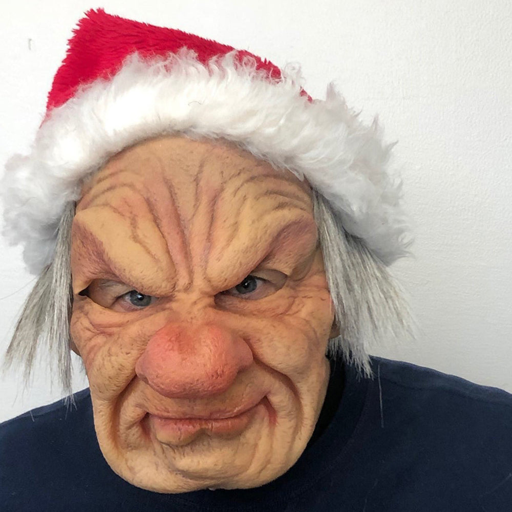 Wrinkled, scowling old man mask with a large red nose and long gray hair, topped with a red Santa hat with white fur trim. 24