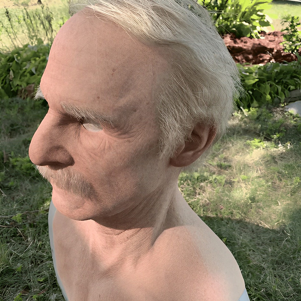 Side angle of the white-haired mustached elderly mask on a chest form another view