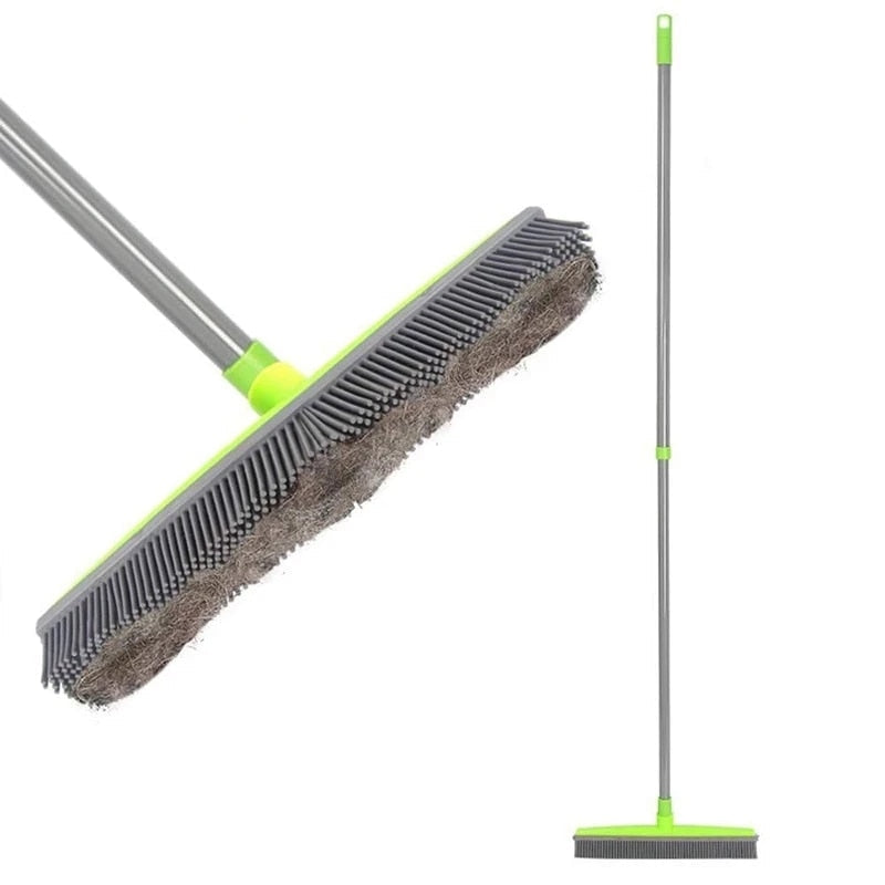 Detail of the gray rubber bristles holding collected hair beside the broom.