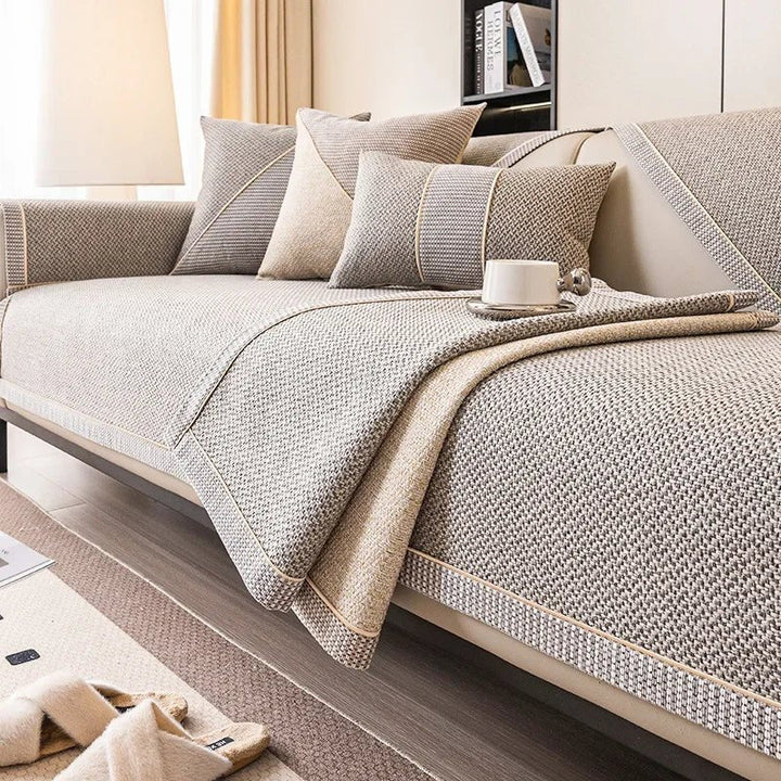Gray woven couch cover with a section turned over to reveal the tan reverse side, beside coordinating pillows. 5