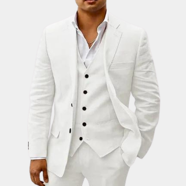 Men's three-piece suit in all-white, detail of the jacket open over a five-button vest and a white open-collar shirt.
