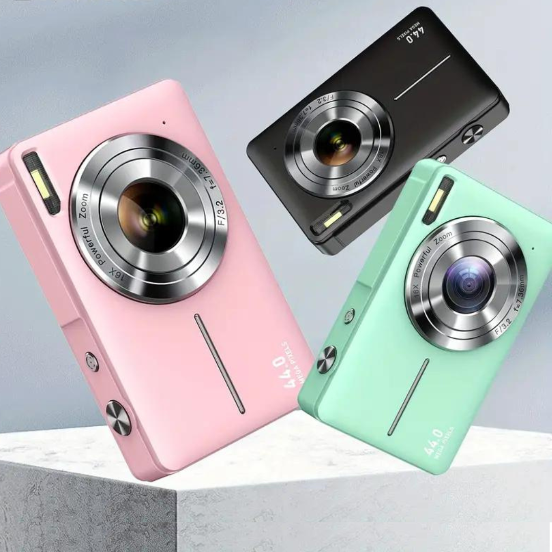 Three compact cameras in pink, black and mint green tilted against a gray background on a stone block 2