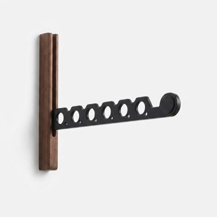 Foldable wooden wall coat rack studio shot with a black metal arm and round holes.