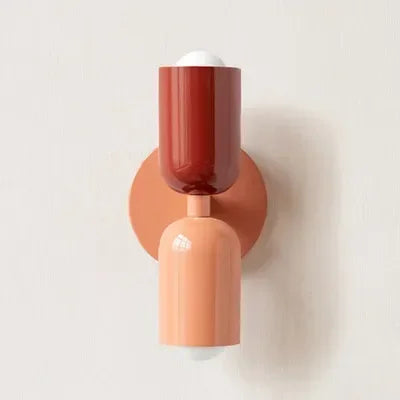 Retro wall lamp with a red top shade, peach lower shade and peach round backplate