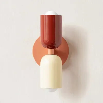 Retro wall lamp with a red top shade, cream lower shade and coral round backplate