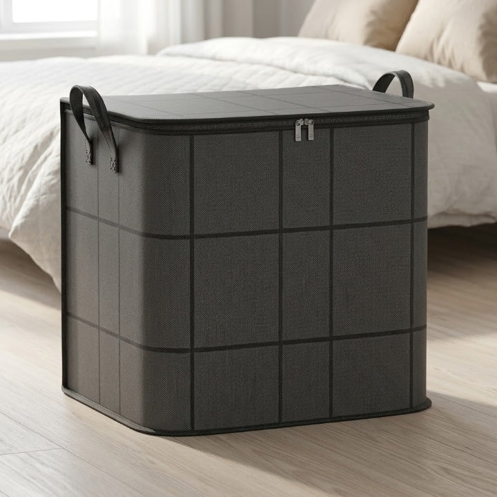 Grey geometric storage bag with two carry handles and a zippered lid beside a bed.