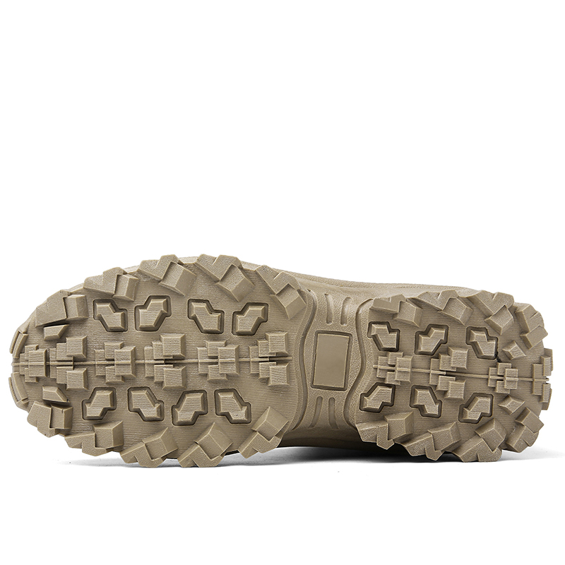 Close-up of the tan boot's outsole, showing the aggressive lug pattern and flat arch area 13