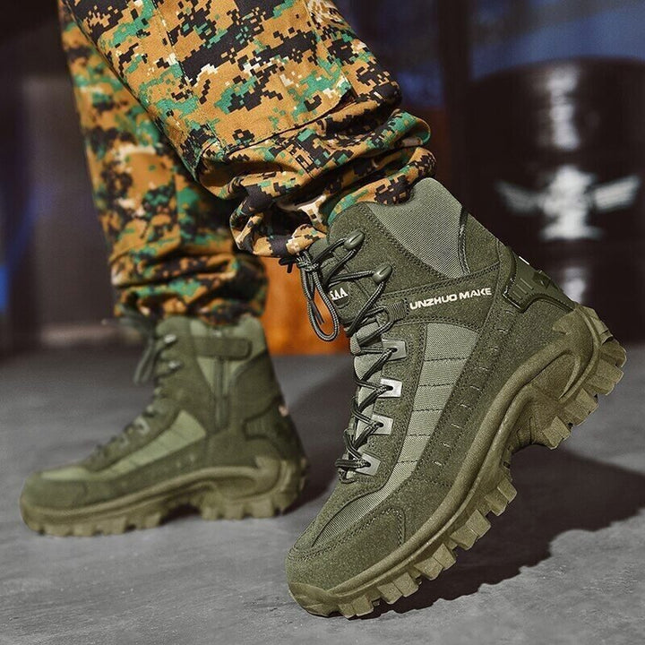 Olive green boots worn with digital camouflage pants, one foot lifted to show the chunky lug sole 5
