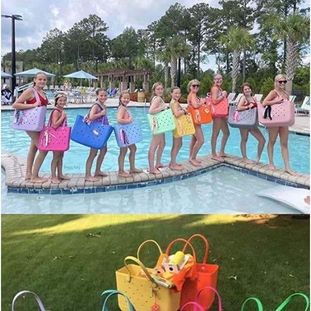 Group of girls and women in swimsuits posing on a pool edge, each holding a different colored tote. 26