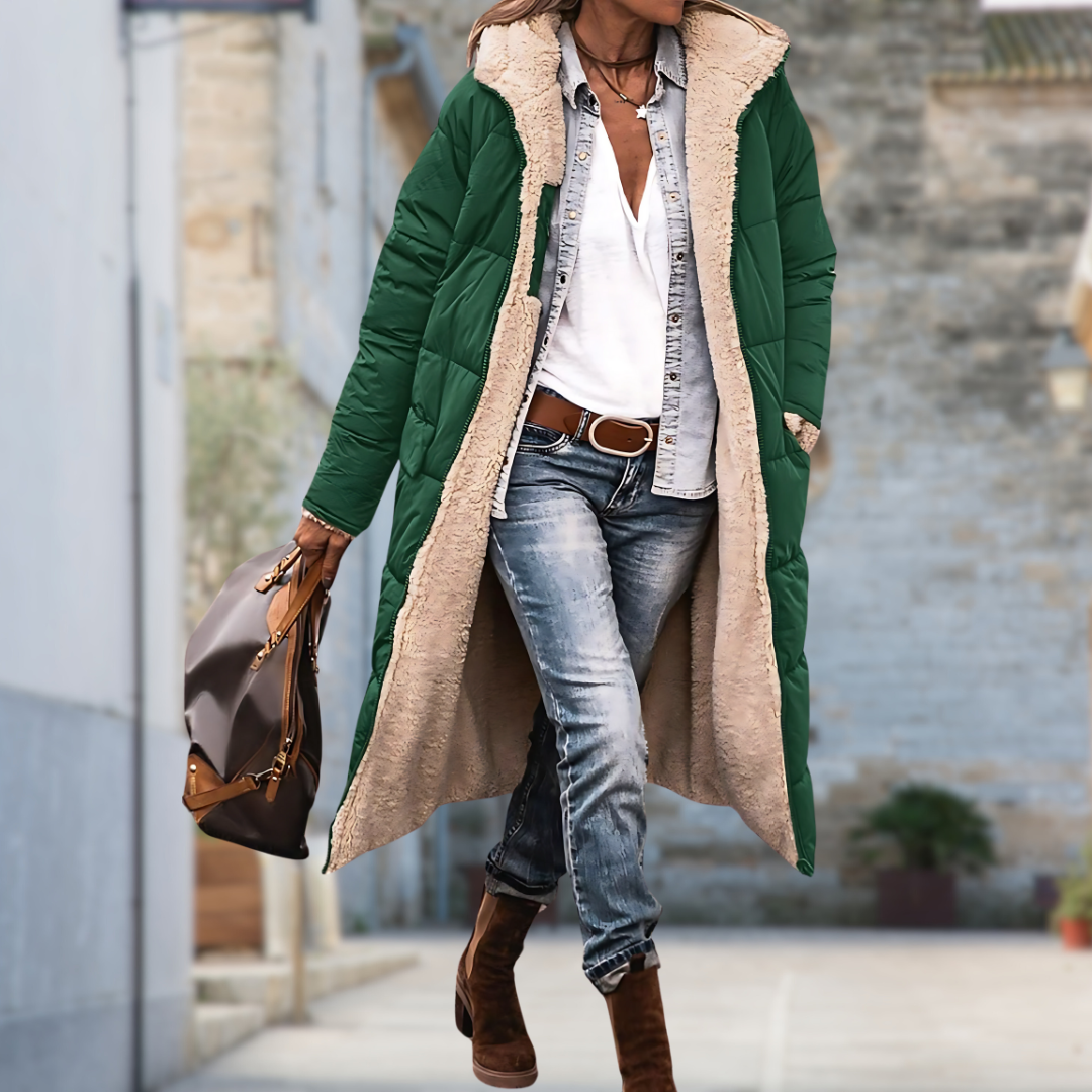 Dark green quilted long coat with fleece lining worn open outdoors over a white top and jeans 7