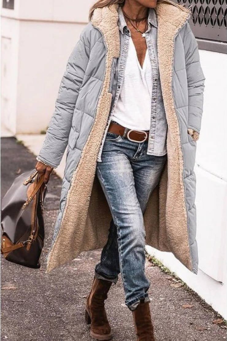 Light gray quilted long coat with fleece lining worn open on a sidewalk with jeans and boots 8