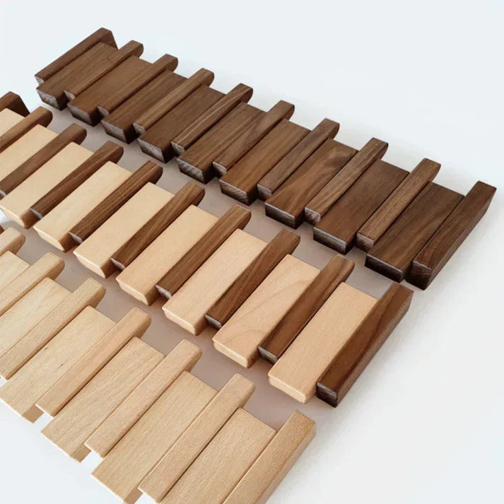 Flat lay of loose wooden blocks in dark walnut and light beech tones before assembly 5