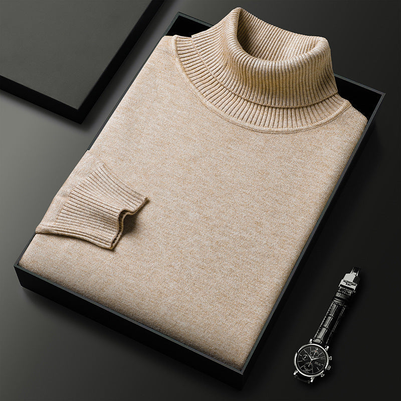 Men's cashmere blend turtleneck sweater in beige, folded in a black gift box beside a leather-strap watch.