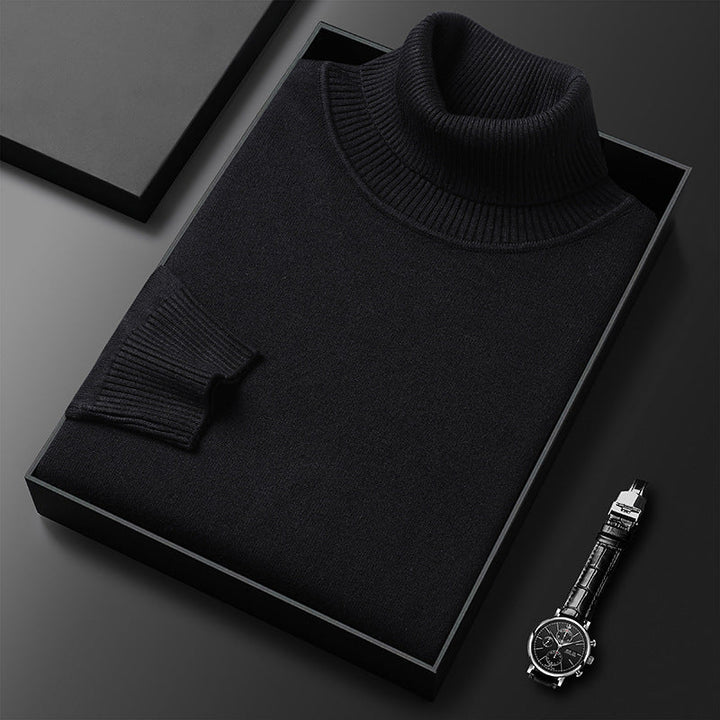 Men's cashmere blend turtleneck sweater in black, folded in a black box next to a watch.