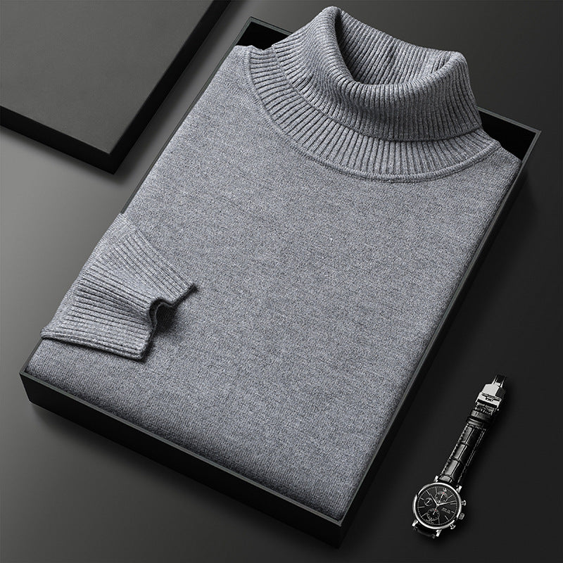 Men's cashmere blend turtleneck sweater in gray, folded in a black box with a leather-strap watch.