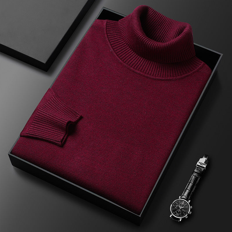 Men's cashmere blend turtleneck sweater in burgundy red, folded in a black gift box beside a wristwatch.