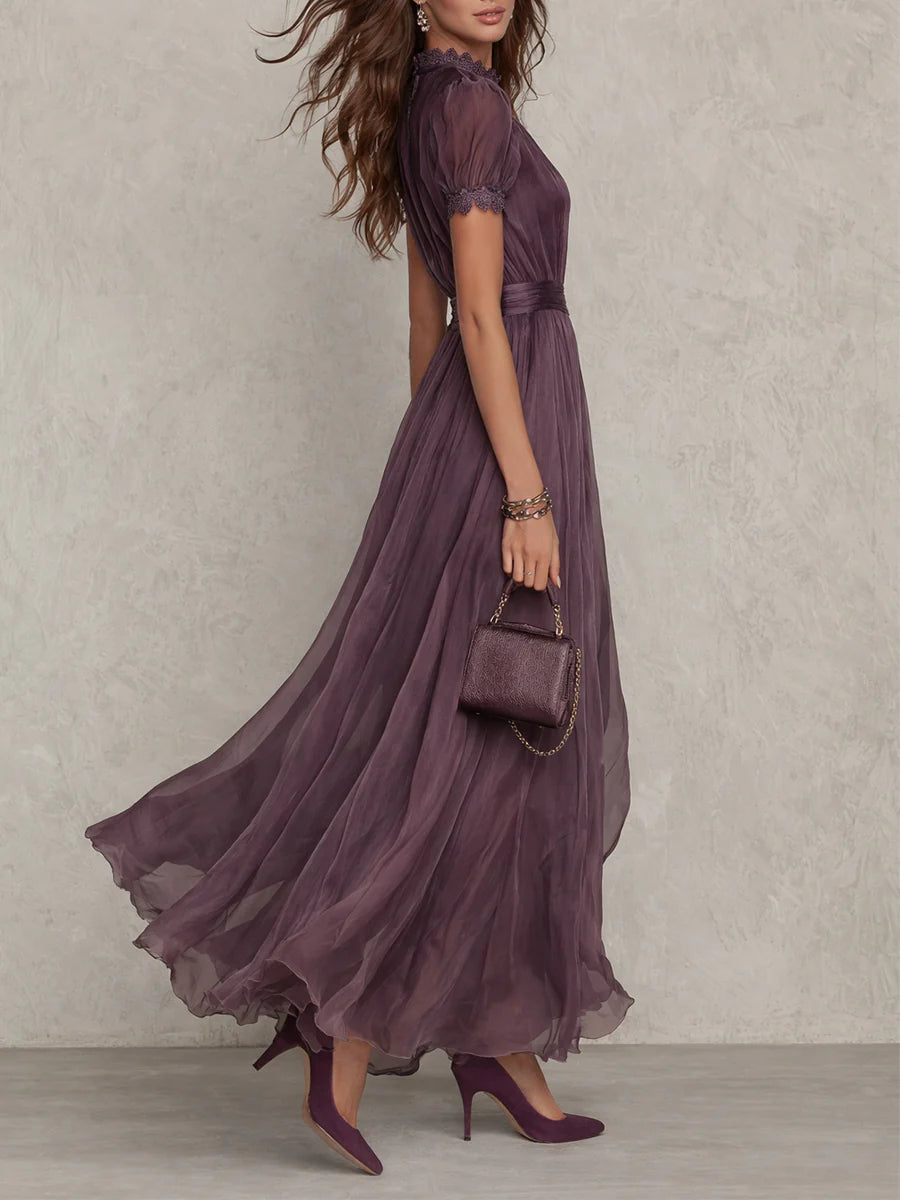 Women's purple maxi dress, side view, with puff sleeves, lace cuffs, and a swirling skirt.
