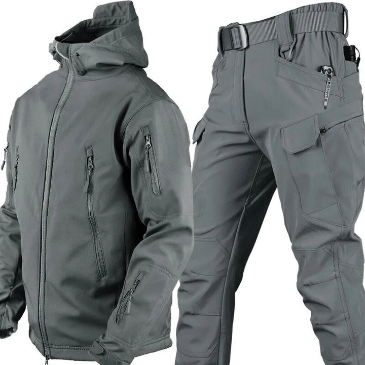Gray hooded jacket and matching cargo pants with belt displayed together, showing the zippered pockets and a pocketed pant leg. 10
