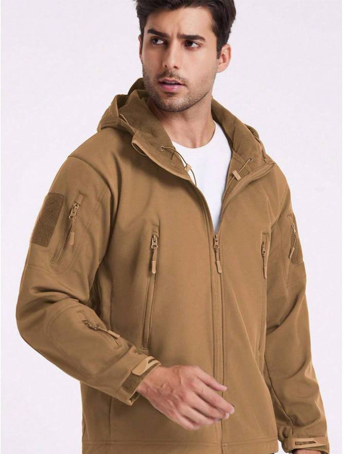 Man in the tan jacket worn open over a white T-shirt, showing the fleece-lined hood and zippered pockets. 17