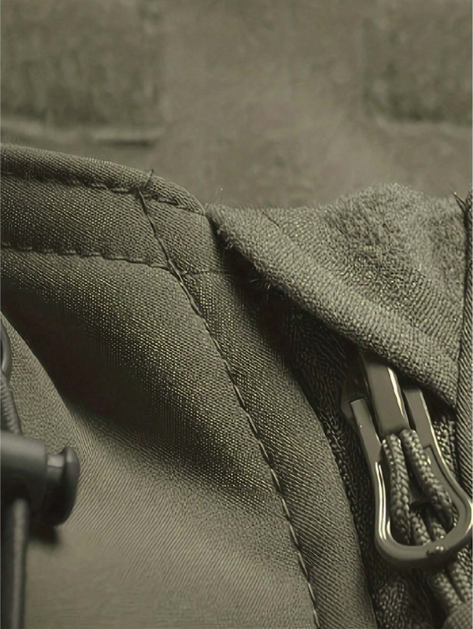 Close-up of the olive green jacket's collar and zipper pull, showing the stitching, fabric texture and soft inner lining. 7